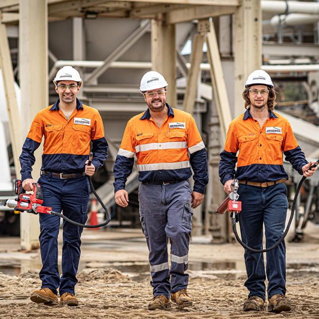 co-founders wearing high visibility and hard hats on a mining site