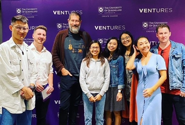 Group of students in front of Ventures media signage