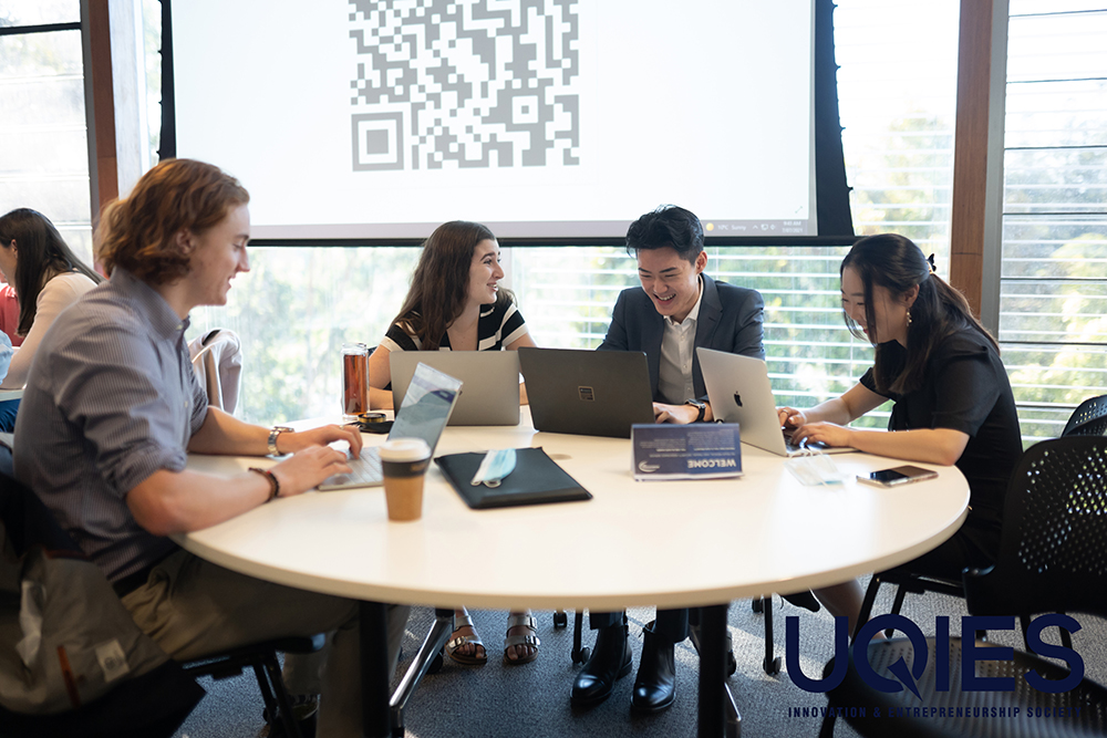 Students at a table working together on laptops