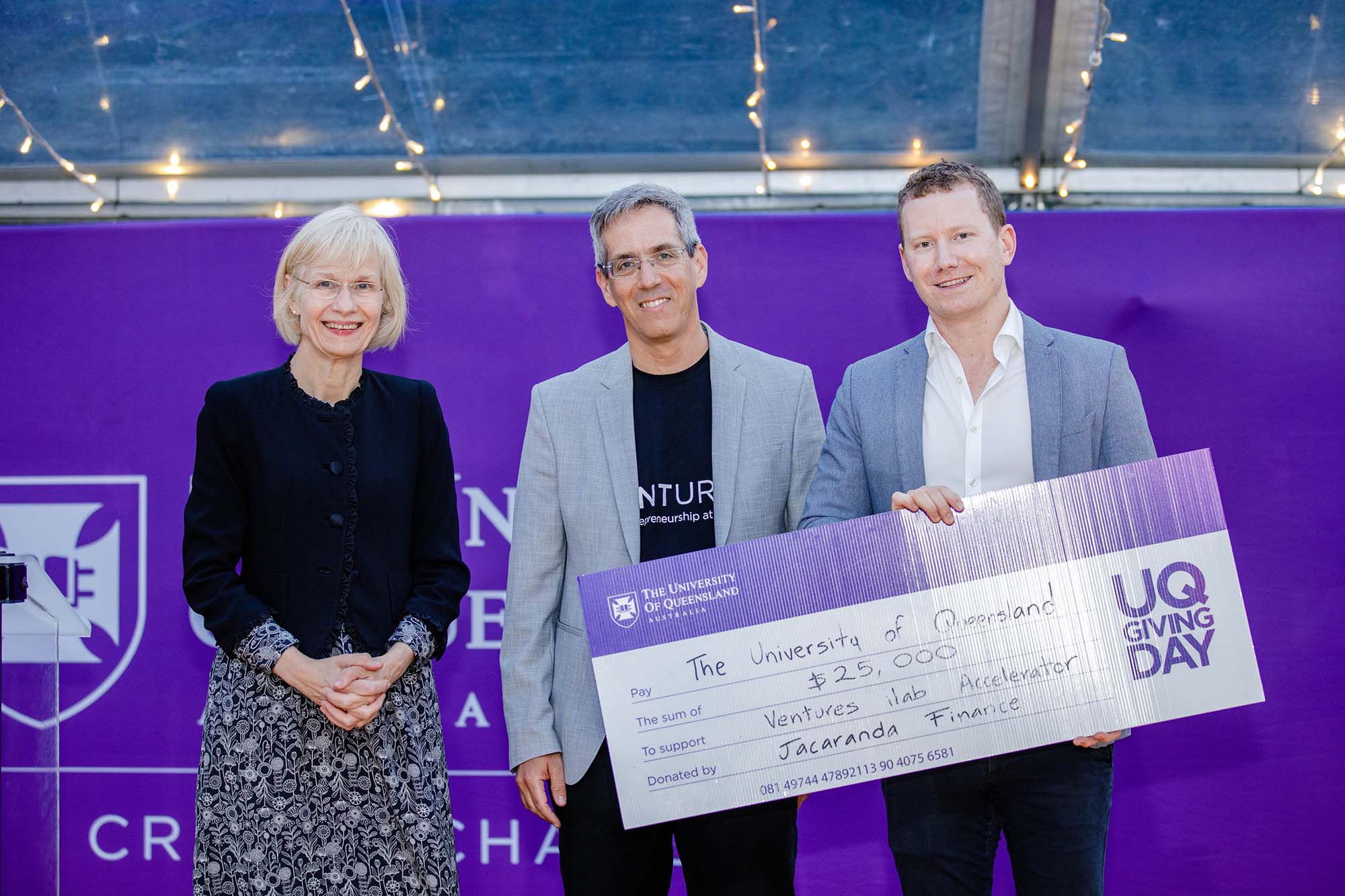 UQ Vice-Chancellor Professor Deborah Terry AO, Head of Entrepreneurship Nimrod Klayman and 2.	Daniel Wessels, CEO of Jacaranda Finance holding novelty sized UQ Giving Day cheque