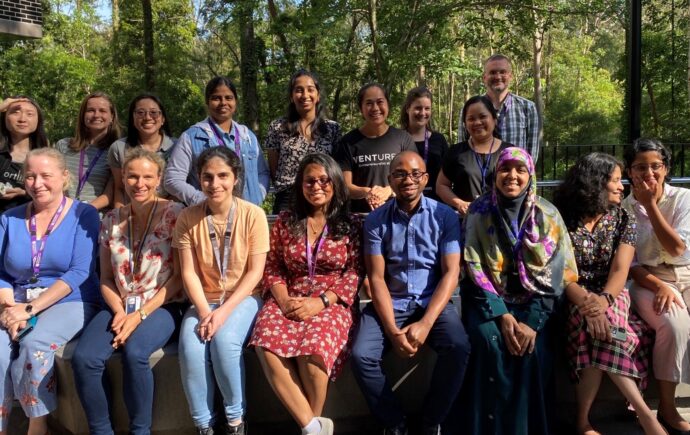 ARC staff and students seated outside in bushy environment