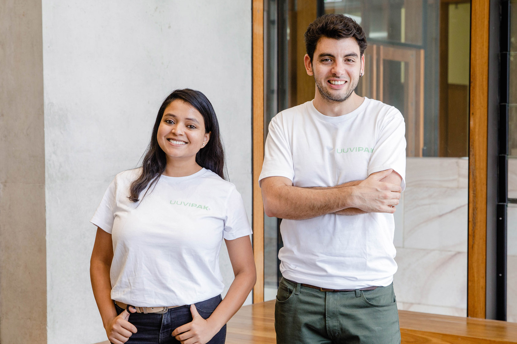 Uuvipak co-founders standing in front of concrete wall