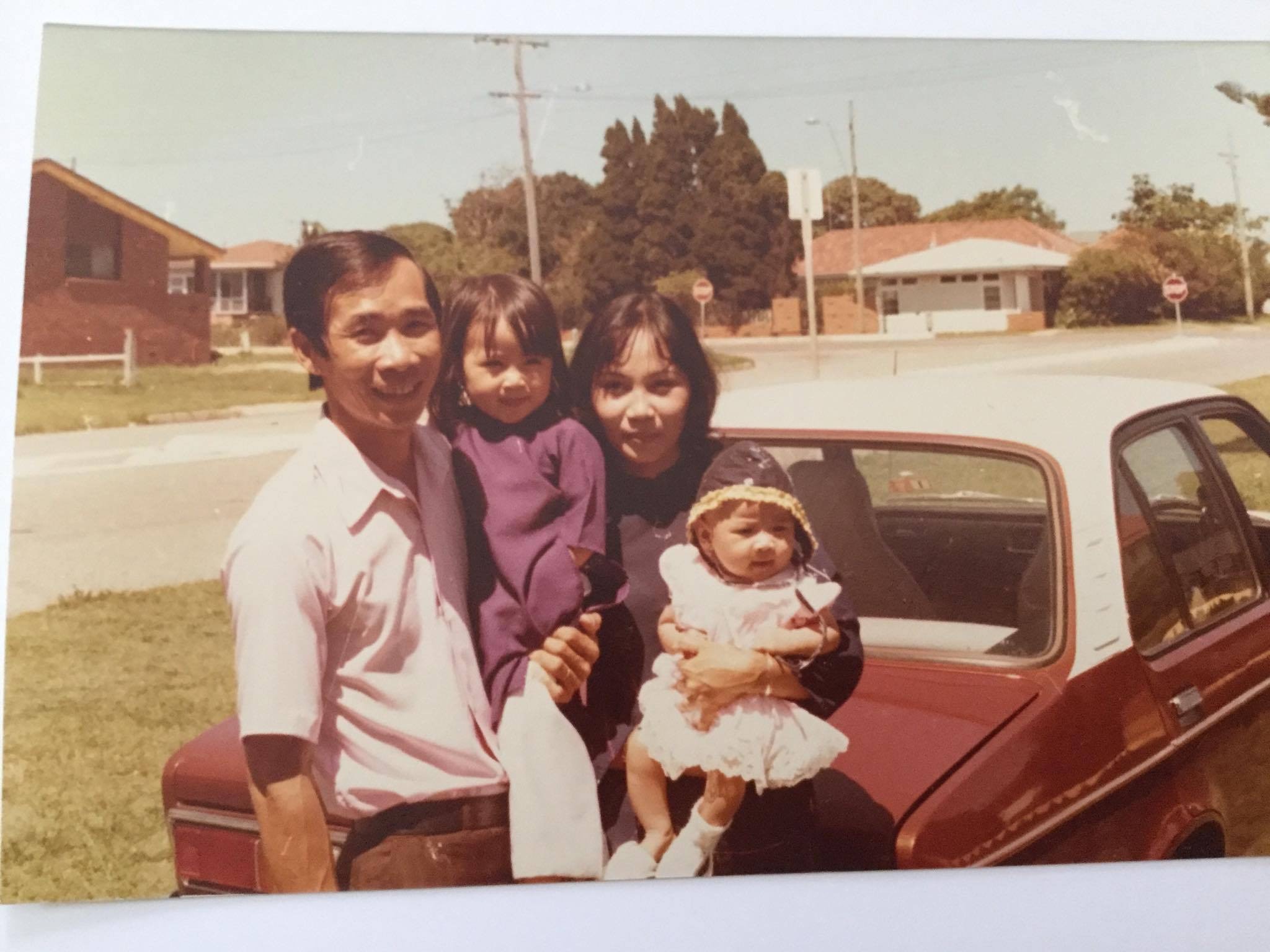 Dr Anh Tran in her mother's arms at Redcliffe in the 1980s. 