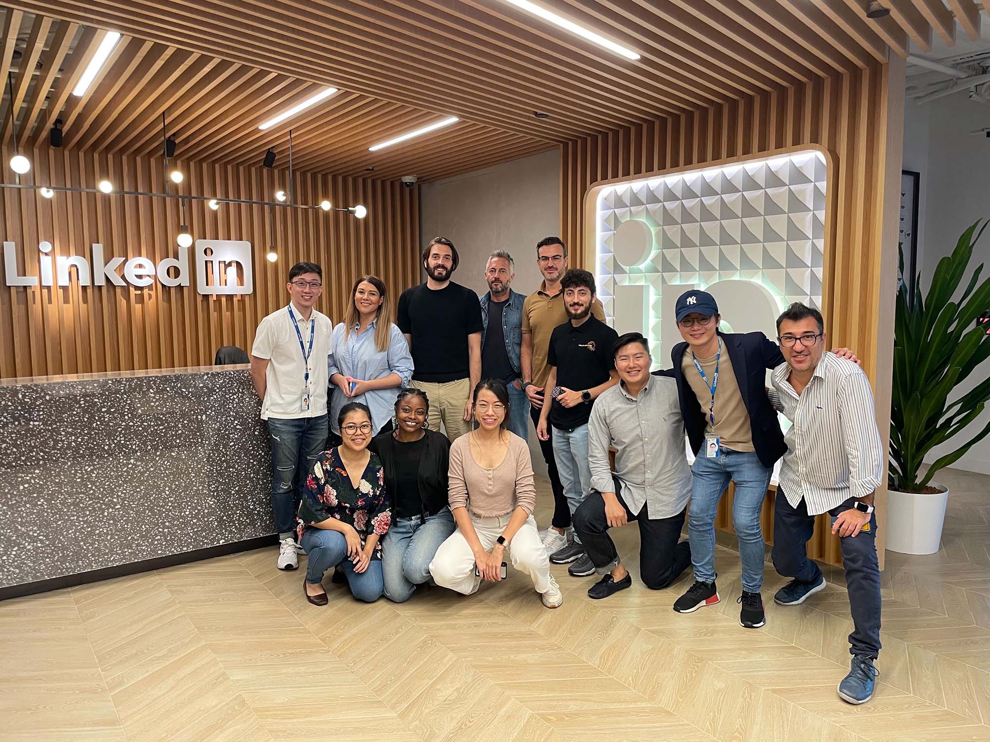 Group of students and staff in front of LinkedIn office sign