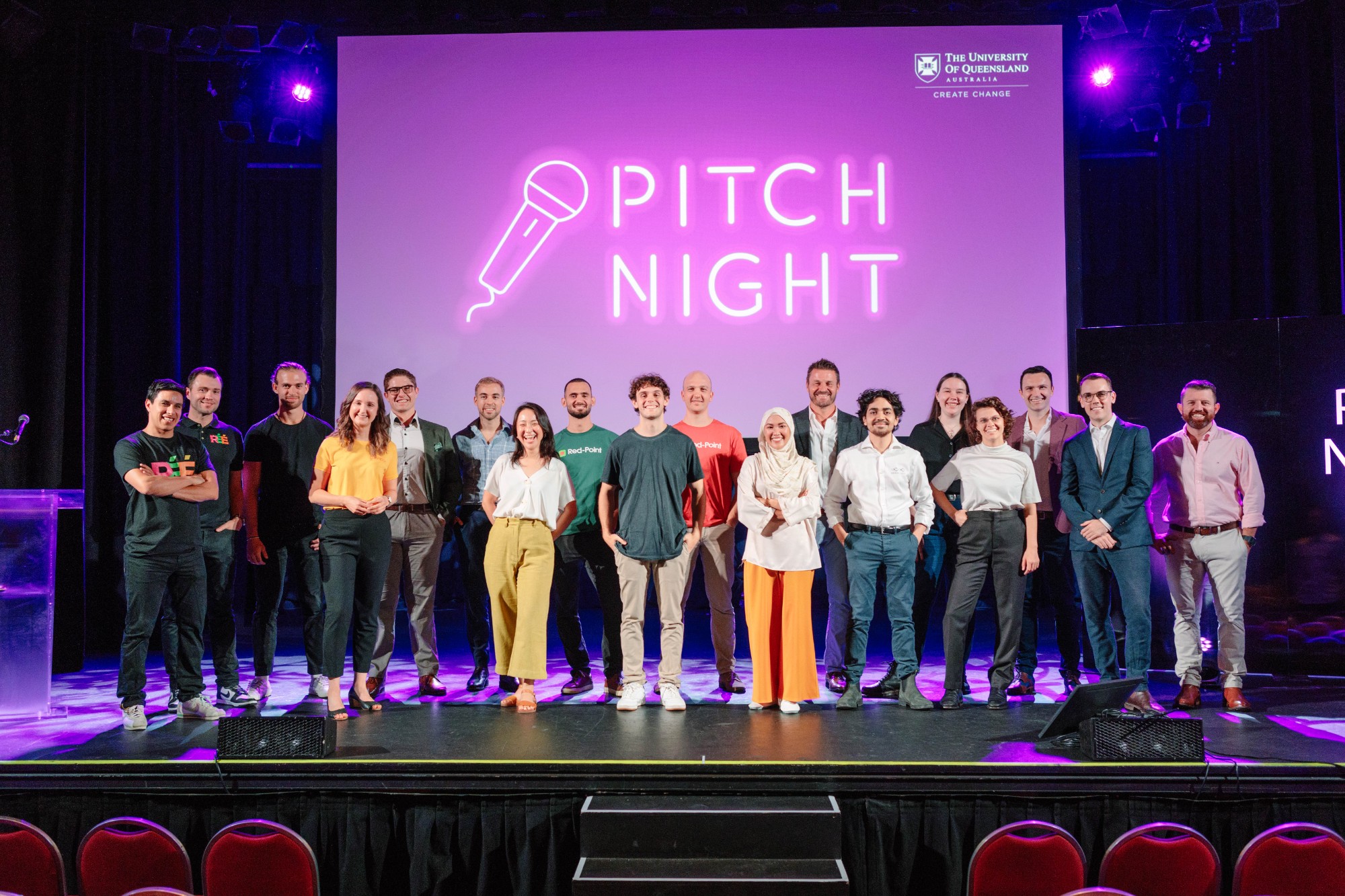 ilab cohort standing on stage at the Tivoli with 'Pitch Night' text on purple screen in the background