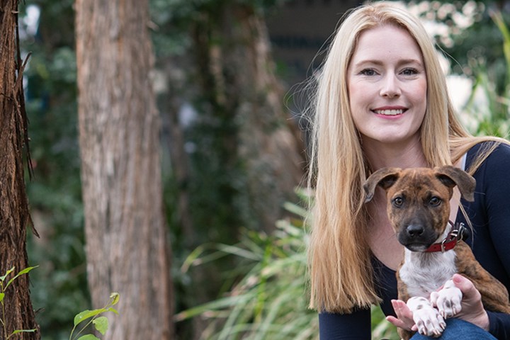 Zoe Black holding a puppy