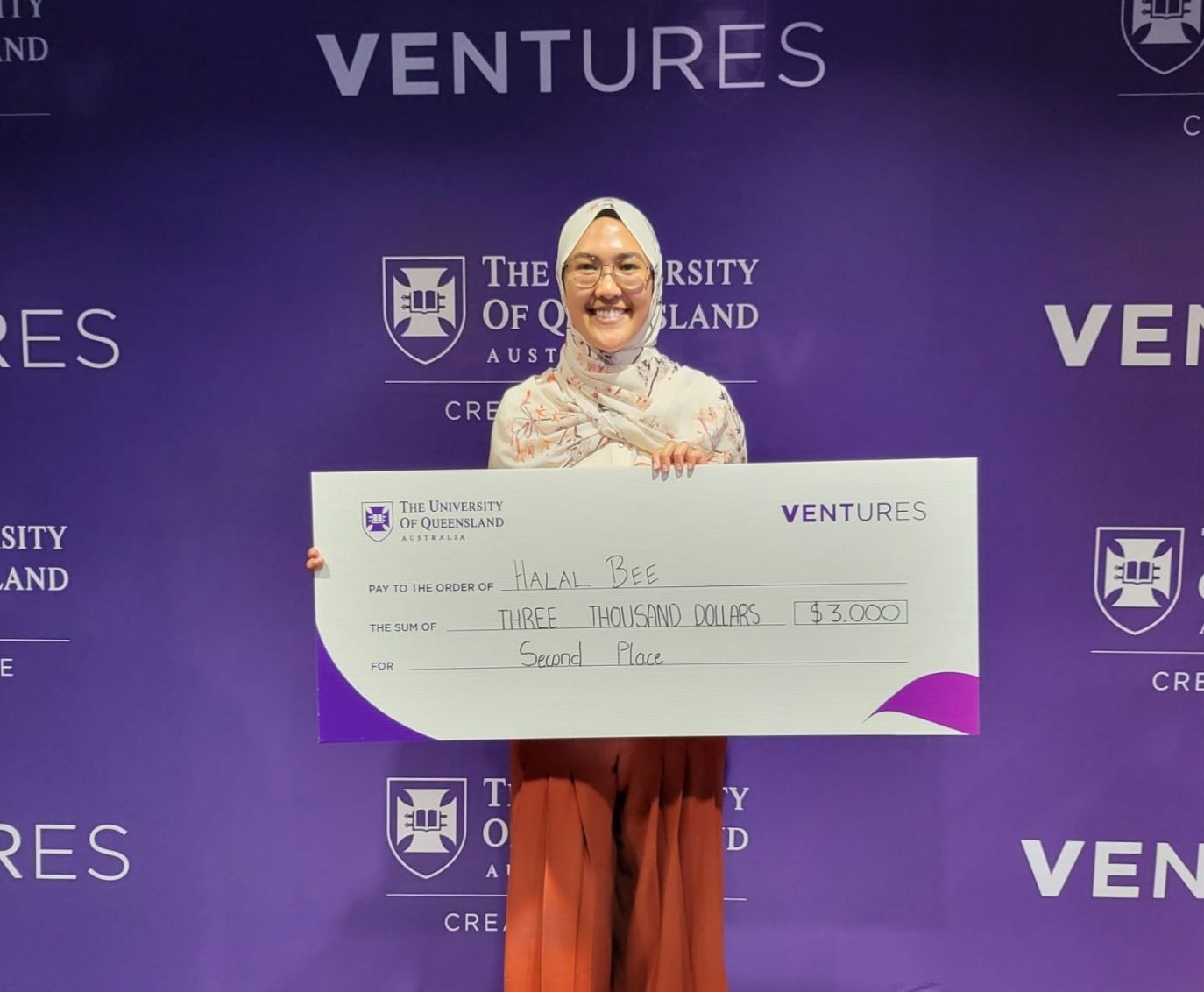 Naajihah Mahmood holding novelty cheque at Validate pitch final