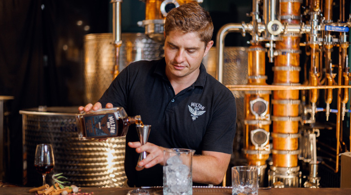 Alexander Bell pouring rum into a glass