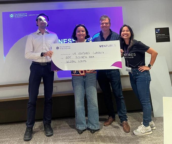 Photo of team Global Scripts with Mayu and their novelty cheque
