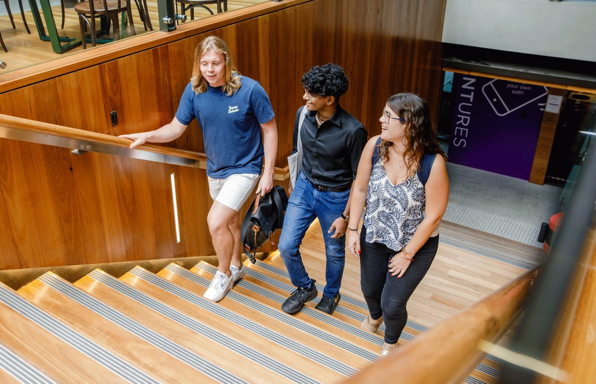 Students walking up the stairs at GCI