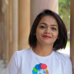 Runali wearing t-shirt with SDG colours representing the 17 UN goals