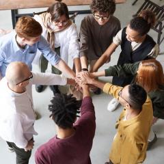 Photo, from above, of a group of people doing a hand cheer