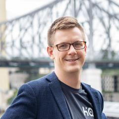 Alastair's headshot outside in front of Story Bridge