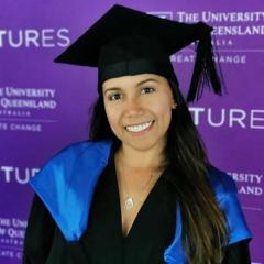 Dayana Jimenez in graduation gown in front of Ventures logos