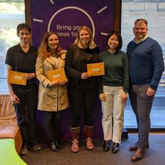 Curiosity PhD Winners 2021 holding awards