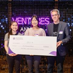 Winners with novelty cheque on stage