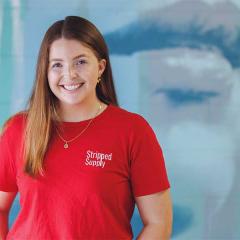 Ashley Hanger in front of a mural