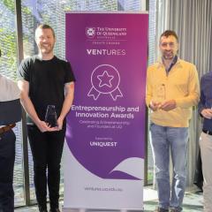 E&I Award Winners Holding Trophies