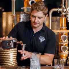 Alexander Bell pouring rum into a glass
