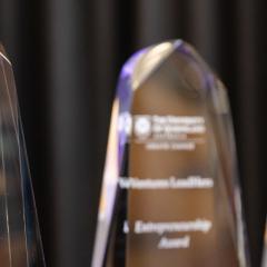 glass award trophies against black background