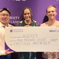 BlueRock group of 5 students for $4000 (one female, four males) holding the winning large cheque 