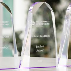 Three clear glass trophies with the Award name engraved upon them: Entrepreneurship Award, Student Award, Community Award