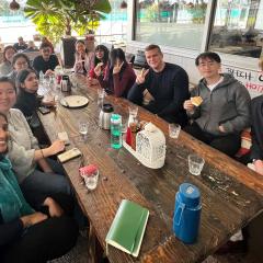 Startup AdVenturers at networking lunch seated at long table 