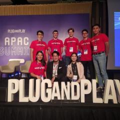 Startup AdVentures in front of 'Plug and Play' big white letters