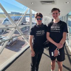 startup adventurers about to board the plane in tunnel to plane