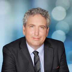 Dr Nigel Greenwood - formal pose; blue lights behind him