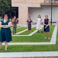 Women standing on grass with dynamic lines