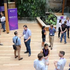 People standing and networking in event space  