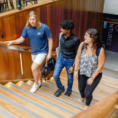 Students walking up the stairs at GCI