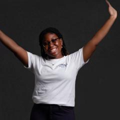 Student with their hands in the air, in celebration