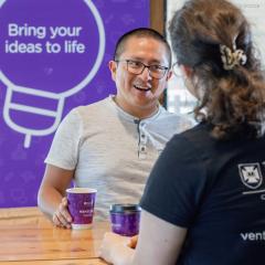 Student having coffee with a Staff member