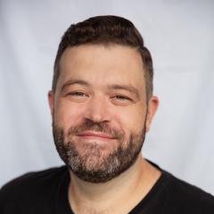 Michael Cotton headshot - full beard and short hair