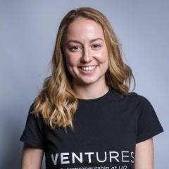 Blond Rachael wearing black t-shirt with Ventures Entrepreneurship at UQ written on it. 