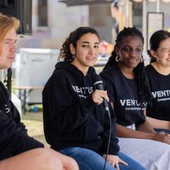 Students talking in a panel discussion at a Ventures event